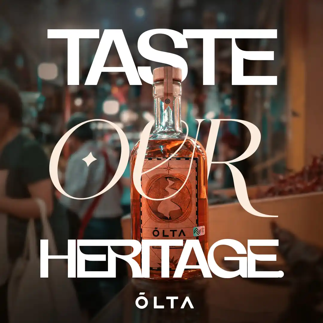 ÓLTA bottle in a warm market setting with bokeh lights